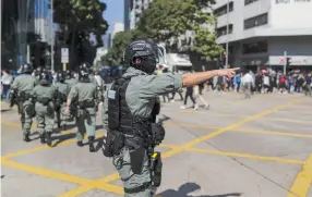  ?? (Marko Djurica/Reuters) ?? RIOT POLICE officer reacts as anti-government office workers attend a lunchtime protest in Hong Kong yesterday.