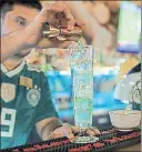  ?? NYT PHOTOS ?? (Left) Football fans watch a World Cup match at La Punto restaurant in Sochi, Russia. The gastro pub is in the building that housed the notorious antidoping laboratory at the centre of doping scandal. (Above) A bartender fixes a drink at the La Punto.