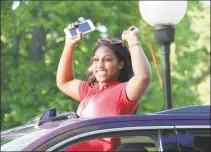  ?? Contribute­d photo ?? Greenwich Academy’s seniors graduated on Monday. Students were driven through the school’s traffic circle by family members, while faculty waved from the driveway.