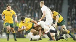  ??  ?? LONDON: Australia’s Will Skelton, falls under the tackles of England’s Chris Robshaw (on ground) during the internatio­nal rugby union match. — AP