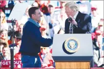  ?? ALEX GOODLETT / AP ?? President Donald Trump shakes hands with Nevada Republican governor candidate Adam Laxalt Saturday at a campaign rally in Elko. Laxalt has been lambasting his Democratic opponent, Steve Sisolak, saying his election will turn Nevada into another California. It’s a line that’s being used by plenty of Republican candidates nationwide this election cycle.