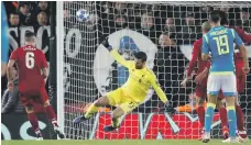  ?? Reuters ?? Liverpool’s Alisson produces a brilliant stop from Arkadiusz Milik on Tuesday to deny Napoli a stoppage-time equaliser