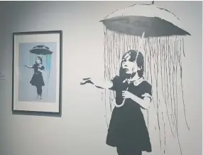  ?? ?? A SCREEN PRINT and a reproducti­on of Banksy’s 2008 post-Hurricane Katrina mural Nola