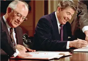  ??  ?? Historic: Mikhail Gorbachev and Ronald Reagan sign the 1987 treaty