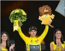  ?? MICHEL EULER/AP PHOTO ?? Colombia’s Egan Bernal stands on the podium after winning the Tour de France on Sunday in Paris.