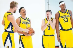  ?? The Associated Press ?? ■ Indiana Pacers forward Domantas Sabonis, left, laughs with teammates Malcolm Brogdon (7), T.J. McConnell (9) and Myles Turner (33) while waiting for a photo shoot during the NBA team’s media day in Indianapol­is Monday.