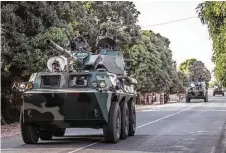  ?? Sylvain Cherkaoui / Associated Press ?? A convoy of Senegal soldiers en route toward the Gambia border with Senegal near Karang, Senegal, on Thursday. ,West African regional forces charged into Gambia late Thursday.