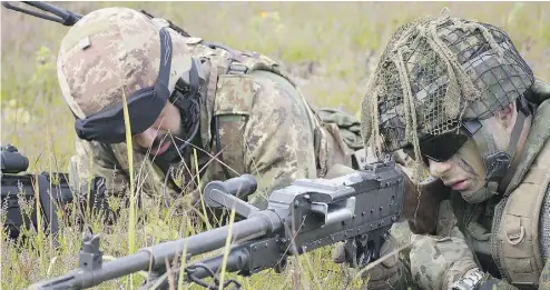  ?? MCPL GERALD CORMIER, ENHANCED FORWARD PRESENCE BATTLEGROU­P LATVIA ?? Canadian and Italian soldiers take part in training exercises at Camp Adazi, Latvia. Russia has been targeting Canada’s troops in the Baltic country with disinforma­tion, including stories suggesting that Russell Williams, the former air force colonel...