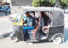  ??  ?? Tuk-tuk driver Mohram Abdul Jelil waits for customers in his motorised three-wheeler on a Cairo street.