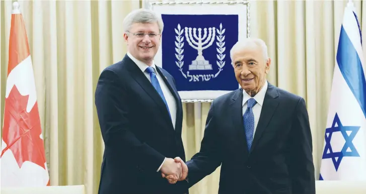  ??  ?? THEN-PRESIDENT Shimon Peres and Canada’s then-prime minister Stephen Harper shake hands before their meeting at the President’s Residence in Jerusalem in 2014.