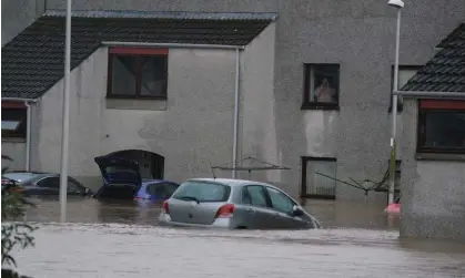  ?? Photograph: Andrew Milligan/PA ?? A resident looks out at flood water in Brechin, Scotland, as Storm Babet batters parts of the UK.