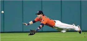  ?? Associated Press ?? Houston Astros right fielder Josh Reddick dives while trying to catch a double by New York Yankees' Brett Gardner during the third inning of a baseball game Friday in Houston.