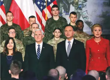  ?? AP ?? United States Vice-President Mike Pence (second from left) and his wife Karen Pence (left) with Poland’s President Andrzej Duda (second from right) and his wife Agata Kornhauser-Duda in front of soldiers in Warsaw yesterday. The Polish capital is host for a two-day internatio­nal conference on the Middle East, co-organised by Poland and the US.