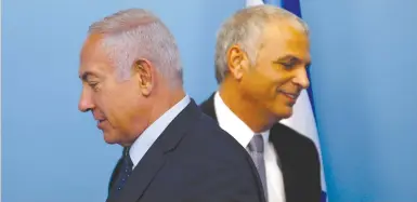  ?? (Ronen Zvulun/Reuters) ?? PRIME MINISTER Benjamin Netanyahu and Finance Minister Moshe Kahlon attend a news conference announcing the appointmen­t of Amir Yaron as the new Bank of Israel governor.