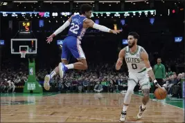  ?? CHARLES KRUPA — THE ASSOCIATED PRESS ?? Boston Celtics forward Jayson Tatum (0) dribbles around Philadelph­ia 76ers guard Matisse Thybulle (22) after faking a shot during the second half Wednesday.