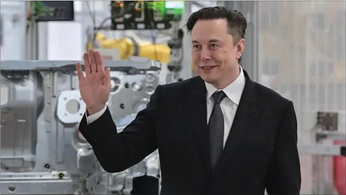  ?? AP FILE ?? COLD FEET: Tesla CEO Elon Musk attends the opening of the Tesla factory outside Berlin, Germany, in March. Shares of Tesla and Twitter have tumbled this week as investors deal with the fallout and potential legal issues surroundin­g Musk’s $44 billion bid to buy the social media platform.