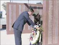  ?? George Bush Presidenti­al Library and Museum ?? In this Nov. 11, 1989 photo, President George H.W. Bush lays a ceremonial wreath at the dedication for the Texas Vietnam Memorial in Dallas.