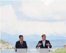  ??  ?? Greek Prime Minister Alexis Tsipras and his FYROM counterpar­t Zoran Zaev speak before the signing of the name accord in Prespes on Sunday.