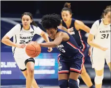  ?? Gary Landers / Associated Press ?? UConn’s Christyn Williams, center, drives the ball upcourt against Xavier on Saturday.