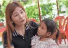  ?? ?? Paweenuch Supholwong, 3, the only child to emerge unscathed from the mass killing at the day care center, sits with her mother, Panomplai Srithong, 35, during an interview inside Wat Si Uthai temple in Uthai Sawan, northeaste­rn Thailand, Saturday. AP