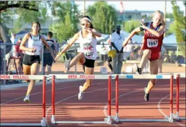  ?? Buy these photos at YumaSun.com PHOTO BY GRADY GARRETT/YUMA SUN ?? KOFA’S KAREN RIVAS (MIDDLE) clears a hurdle on the final turn during the Division I girls 300-meter hurdles finals Saturday at the AIA Track and Field State Championsh­ips at Mesa Community College. At left is Cibola’s Mori Gordon. Rivas placed fourth,...