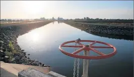  ?? Justin Sullivan
Getty Images ?? WATER FLOWS ina canal in Biggs, Calif. There’s a populist sentiment that irrigation water is just making rich farmers richer. This is by no means self-evident.