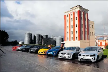  ?? PHOTO: COURTESY SAMANTHAOL­IVEPHOTOGR­APHY ?? A colourful array of Holden cars line-up in front of Tui Brewery with Tui girls Holly (left) and Candie during the Mangataino­ka Motors Holden versus Ford Car Day held on Sunday July 29.