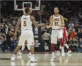  ?? PHIL LONG — THE ASSOCIATED PRESS ?? Jose Calderon celebrates with J.R. Smith after making a 3-point shot against the Pelicans on March 30.