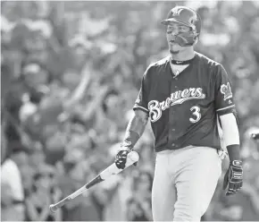  ?? JON DURR / USA TODAY SPORTS ?? Brewers shortstop Orlando Arcia walks back to the dugout after striking out in the ninth inning Saturday.