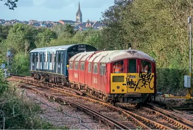  ?? ?? An unusual and never-to-be-repeated movement on the Isle of Wight’s Island Line on October 20 saw Class 483 unit No. 483006 propelled from Ryde St John’s works to Sandown by one of its replacemen­ts, Class 484 ‘D-train’ No. 484004, using a bespoke temporary adaptor coupling and with speed reduced to 5mph. With No. 483006 being the last of the 1938-built tube trains still at Ryde, this was the most convenient way to get it to the road loading point at Sandown for its movement on low-loader to the Llanelli & Mynydd Mawr Railway. Unit No. 483008 is in storage at Sandown and will follow its classmate to the LMMR. JOHN FAULKNER