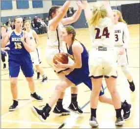  ?? Westside Eagle Observer/MIKE ECKELS ?? Decatur’s Sammie Skaggs (center) fights her way past a gauntlet of Lady Warriors on the way to the basket during the Life Way-Decatur non-conference varsity contest Jan. 8 in the gym at First Baptist Church of Centerton. Skaggs managed to sink her shot for two of her 14 points to lead the Lady Bulldogs to a 48-40 victory over the Lady Warriors.