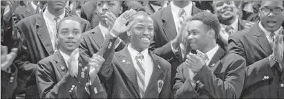  ?? | JESSICA KOSCIELNIA­K~SUN-TIMES ?? Urban Prep student Derrick Newton is recognized during tie celebratio­n on Thursday.