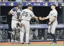  ?? Steve nesius / Associated Press ?? the Yankees’ Gary Sanchez, left, and Gleyber torres (25) congratula­te Brett Gardner after his leaping catch on the warning track of a fly ball hit by the tampa Bay rays’ Brandon Lowe to end the sixth inning.