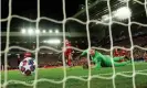  ??  ?? Marcos Llorente compounds Adrián’s mistake by firing Atlético’s first goal past the Liverpool keeper’s feeble dive. Photograph: Peter Powell/EPA