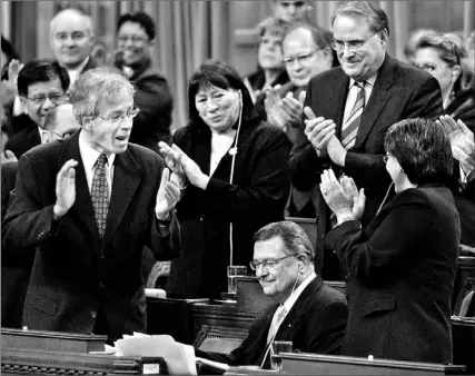  ?? CHRIS WATTIE/ CP ?? Finance Minister Ralph Goodale, seated, receives a standing ovation from Liberal MPs in the House of Commons yesterday. Goodale had responded to opposition questions about the government’s mini-budget that was released on Monday.