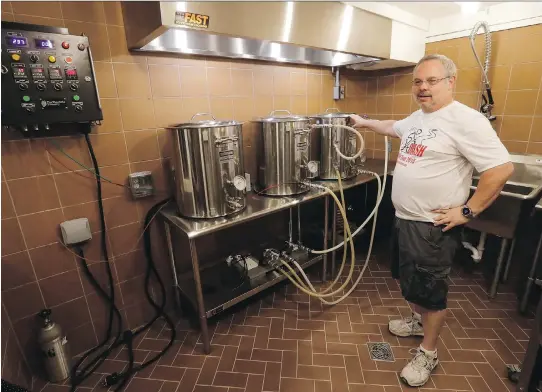  ?? MORRY GASH/THE ASSOCIATED PRESS ?? Steve Clemens works on a batch of beer in his home basement brewery in Lodi, Wis. Clemens says brew rooms “get a lot of attention” when friends pay a visit. He says he retrofitte­d one into the basement of his old house, and also worked with a contractor to add one in an unfinished space in his new house.