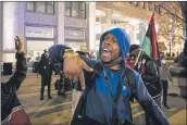  ?? ASHLEE REZIN GARCIA — CHICAGO SUN-TIMES ?? Lamon Reccord leads a chant as dozens of protesters march down the Magnificen­t Mile in Chicago.