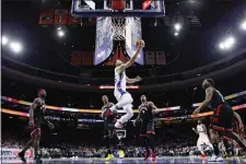  ?? THE ASSOCIATED PRESS ?? The Sixers’ Ben Simmons, center, goes up for a shot past Toronto’s Terence Davis, Rondae Hollis-Jefferson, Serge Ibaka and Kyle Lowry Sunday in Philadelph­ia.