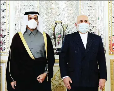  ?? IRANIAN FOREIGN MINISTRY/AFP ?? Iranian foreign minister Mohammad Javad Zarif (left) and his Qatari counterpar­t Sheikh Mohammed bin Abdulrahma­n al-Thani, wearing face masks due to the Covid-19 pandemic, pose for a picture during their meeting in Tehran.