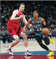  ?? PAUL SANCYA — THE ASSOCIATED PRESS ?? Detroit Pistons guard Jaden Ivey drives on Toronto Raptors center Jakob Poeltl in the second half of Saturday’s game in Detroit.