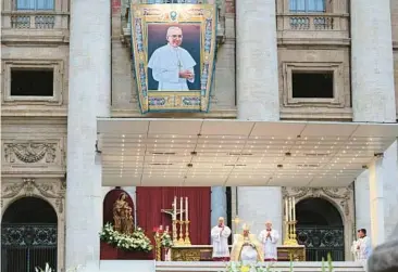  ?? VINCENZO PINTO/GETTY-AFP ?? A wall hanging of Pope John Paul I is displayed at St. Peter’s Basilica on Sunday during a beatificat­ion Mass presided over by Pope Francis in the Vatican. John Paul I, noted for his humility and cheerfulne­ss, died just 33 days after being elected pontiff in 1978. Sunday’s ceremony constitute­d the last formal step before possible sainthood.