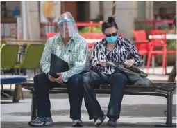  ?? (Olivier Fitoussi/Flash90) ?? PEOPLE WEAR masks in Jerusalem’s city center yesterday. Critics are worried that citizens’ private informatio­n will be abused by various government agencies or foreign actors.