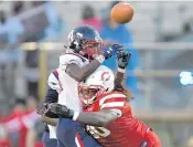  ?? MICHAEL LAUGHLIN/SUN SENTINEL ?? Plantation’s Kahlill Bryan hits Miramar running back Kevin Ross during the first half of Friday’s game.