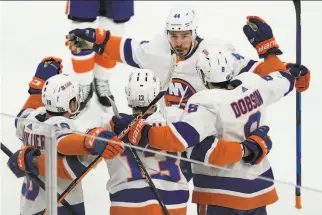  ?? Elise Amendola / Associated Press ?? The Islanders celebrate a powerplay goal scored by by center Mathew Barzal (13) during the first period of their Game 5 victory over the Bruins in Boston.
