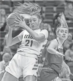  ?? MATT DAYHOFF/JOURNAL STAR ?? Peoria Notre Dame’s Kaitlin Cassidy (21) pulls down a rebound over Lincoln’s Taryn Stoltzenbu­rg in the first half of their nonconfere­nce game on January 20 at Renaissanc­e Coliseum in Peoria.