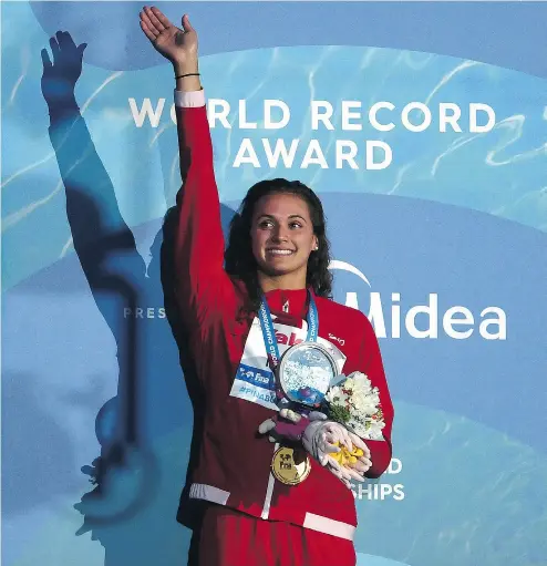  ?? LAURENCE GRIFFITHS / GETTY IMAGES ?? Kylie Masse of Canada with the gold medal she won in the women’s 100-metre backstroke final.