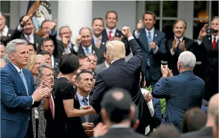  ?? PHOTOS: REUTERS ?? President Donald Trump, centre, celebrates with Congressio­nal Republican­s in the Rose Garden of the White House after the House of Representa­tives approved the American Healthcare Act, to repeal major parts of Obamacare and replace it with the...