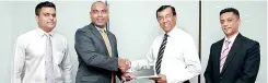  ??  ?? From left: Regus Country Manager Dr. Nirmal De Silva (second from left) exchanging the workspace agreement with SLASSCOM Chairman Jayantha De Silva at Regus Business Centre Colombo 4 in the presence of SLASSCOM Executive Director Dharshan Cooray (first...