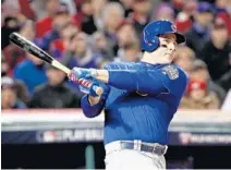  ?? EZRA SHAW/GETTY IMAGES ?? Chicago’s Anthony Rizzo doubles to score Kris Bryant against Cleveland during the first inning in Game 2 of the World Series on Wednesday.