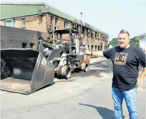  ?? Dave Savides ?? NCT GM Danny Knoesen points out a loader and workshop which were totally gutted in the blaze